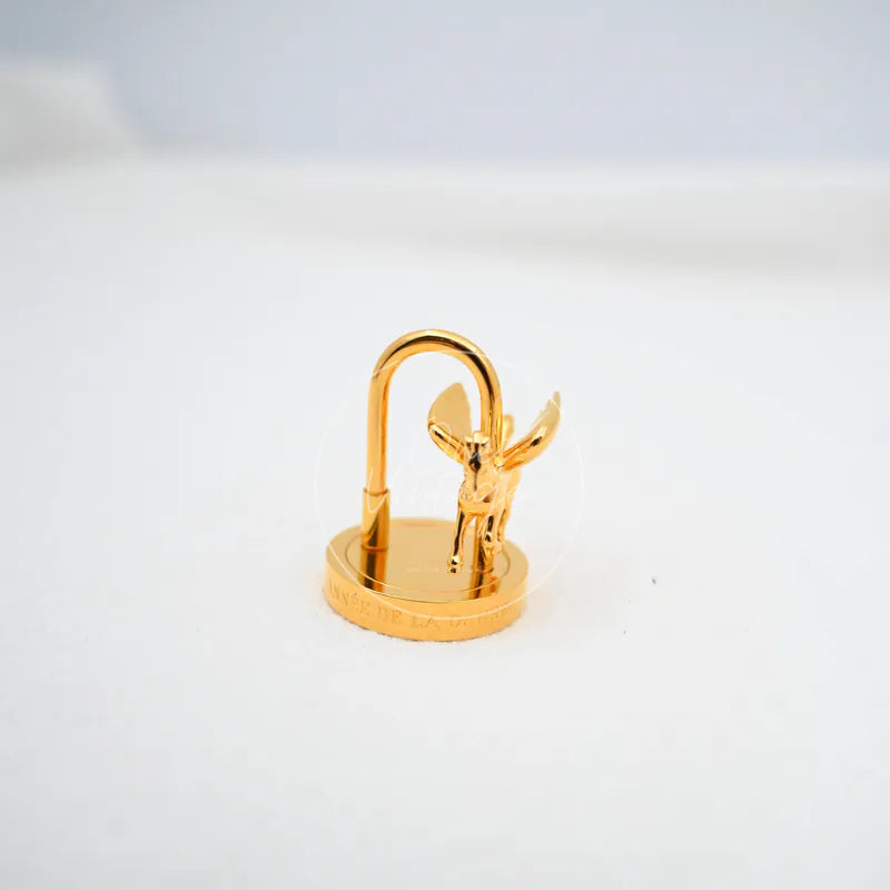 Hermès Pegasus Cadena Charm in gold, featuring winged horse motif and arched shackle, front three-quarter view