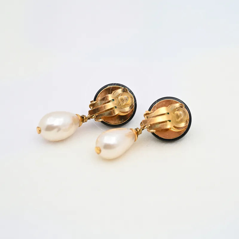 Chanel Teardrop Pearl CC Dangle Earrings, gold-tone clasp hardware and circular clip-on earring backs detail