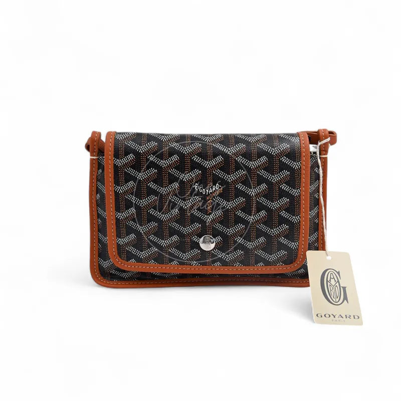 Goyard Plumet Pocket Wallet With Strap in black and tan, featuring snap button closure and monogram canvas, front view