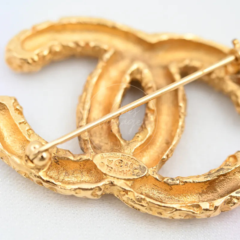 Chanel Vintage CC Mark Brooch in 24K gold-plated, featuring pin-back closure and rear fastening hardware, back view
