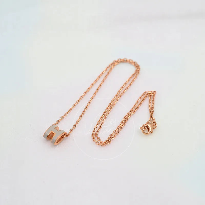 Hermès Mini Pop H Grey Pendant Necklace with Rose Gold in gold-plated alloy metal, featuring lobster clasp and H-shaped pendant, front view