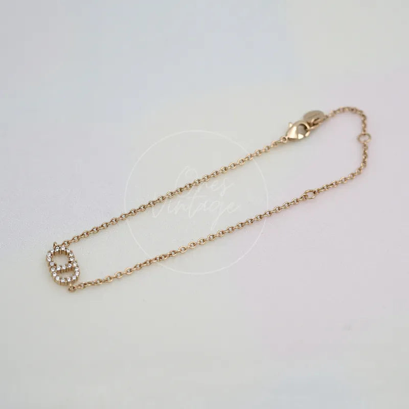Dior Clair D Lune Bracelet in alloy metal, featuring lobster clasp and decorative logo pendant, front view