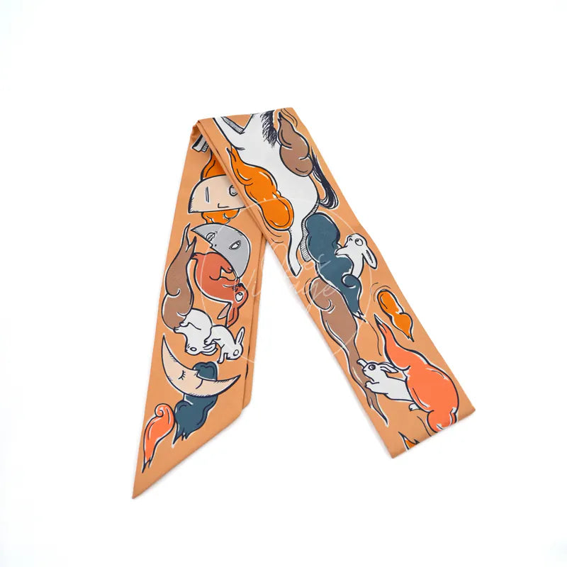 Hermès Mille et Un Lapins Twilly in orange silk 100%, featuring rabbit-themed illustrated print and tapered scarf ends, front view
