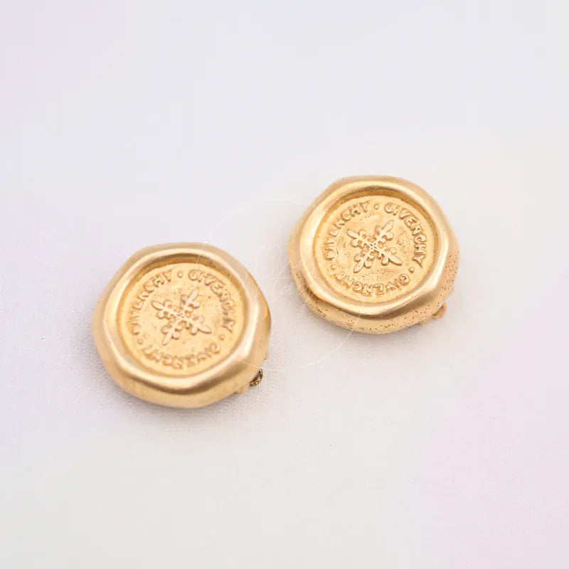 Givenchy Vintage Circle Wax Seal Stamp Earclips in alloy metal, featuring central floral motifs and paired circular earclips, front view