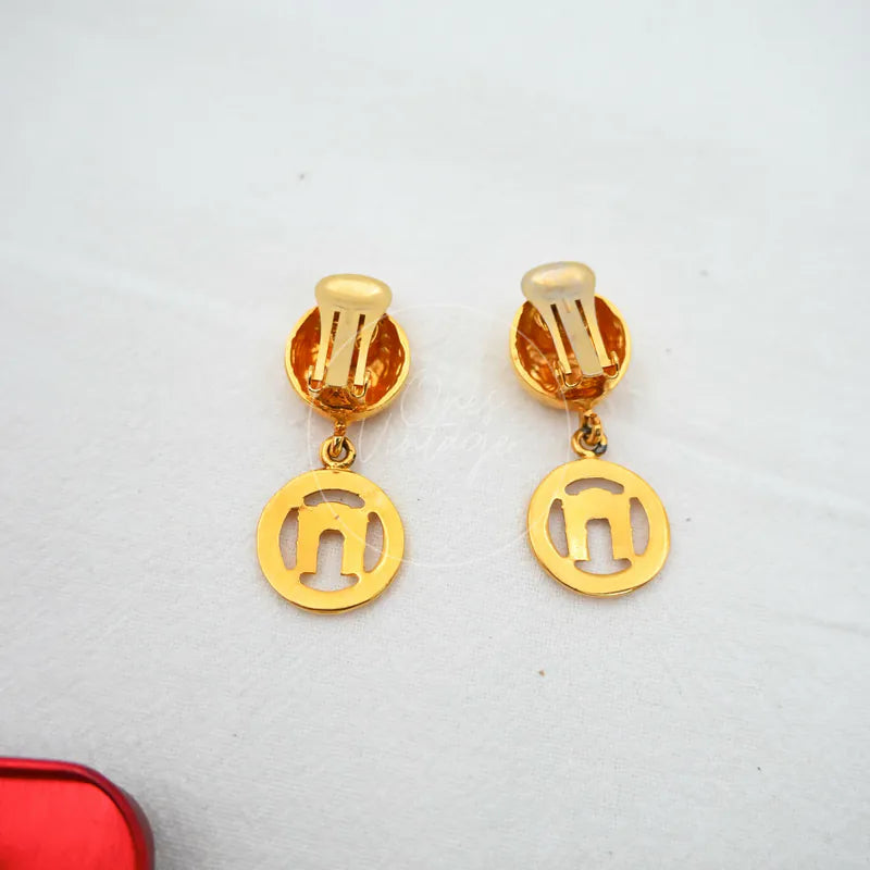 Celine Vintage Earrings in gold plate, featuring circular cut-out drop motifs and clip-on fastenings, front view