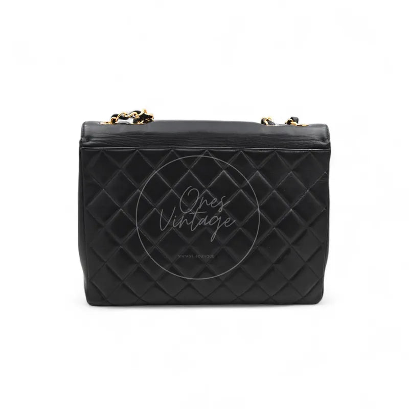 Chanel Vintage Maxi CC Straight Flap Bag in black lambskin with gold-tone hardware, featuring top flap and chain strap, front view