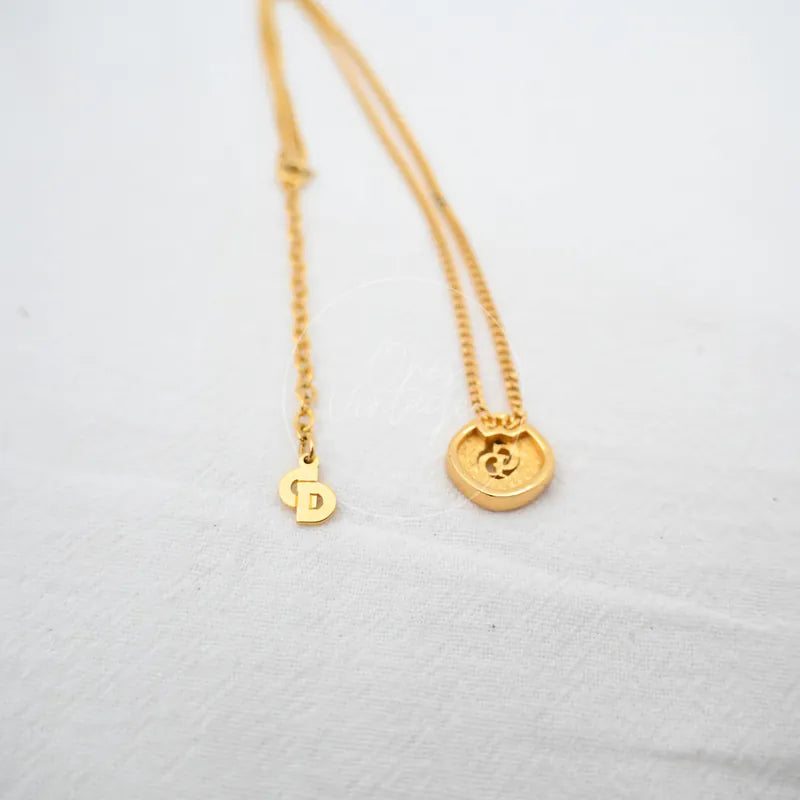 Dior CD-pendant Necklace in plated gold and rhinestone, featuring circular logo pendant and fine chain, front view