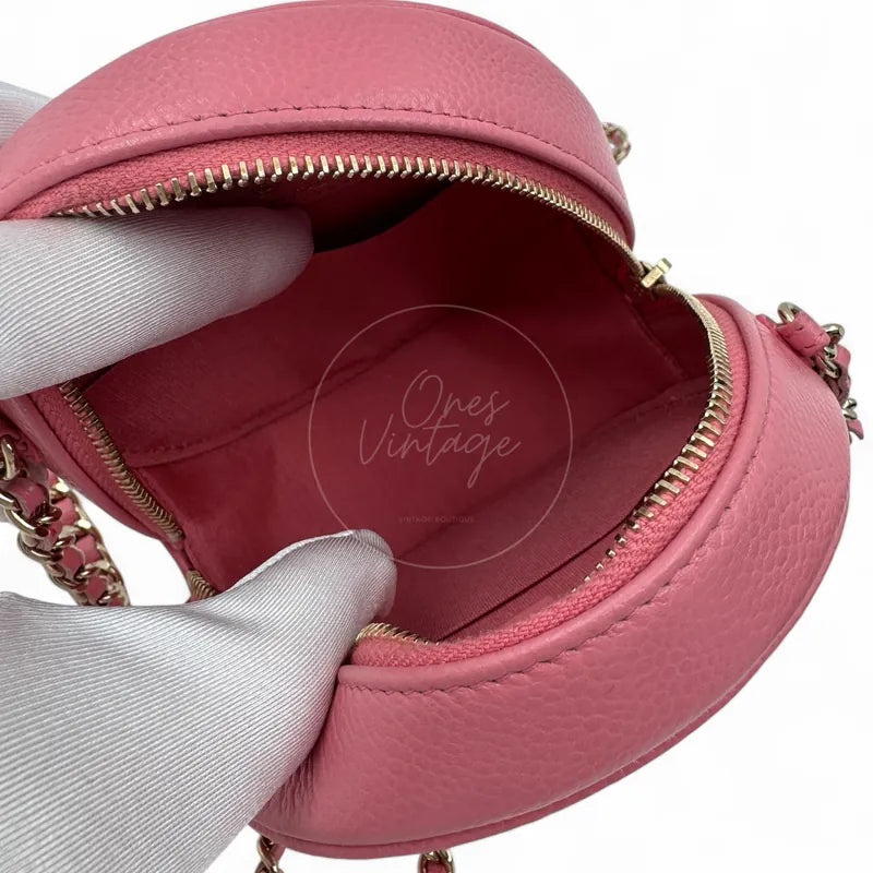 Chanel round clutch bag in pink camellia-embossed caviar leather with gold hardware, Series 29, open pink textile interior