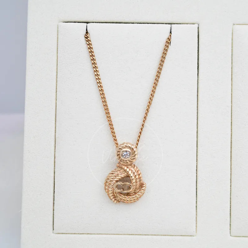 Dior Vintage CD logo Knot Metal with plated Necklace in gold-plated metal and crystal, featuring interlocking CD pendant and central stone, front view