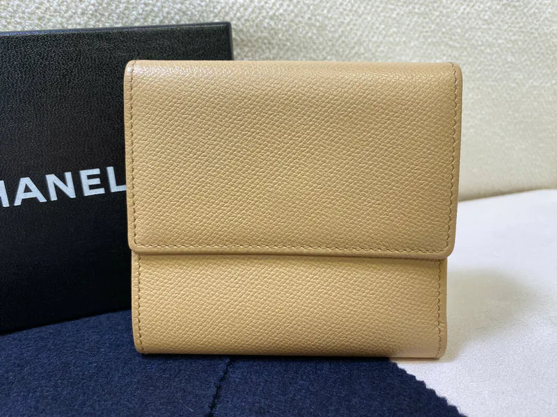 Chanel CC Logo Compact Trifold Wallet in beige calfskin, featuring fold-over flap and textured leather surface, front view