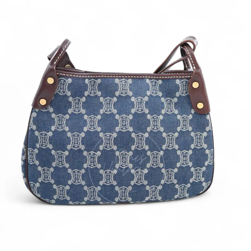 Celine Macadam Shoulder Bag in blue denim, featuring all-over monogram pattern and brown leather handle attachments, front view