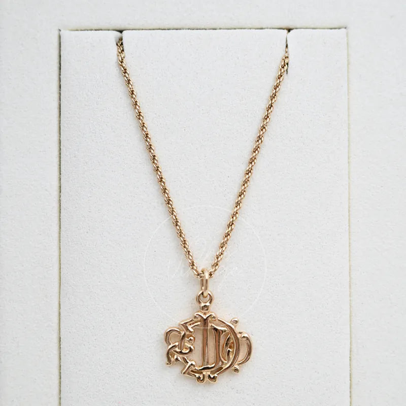 Dior Vintage Necklace in alloy metal, featuring ornate scrollwork pendant and twisted chain, front view