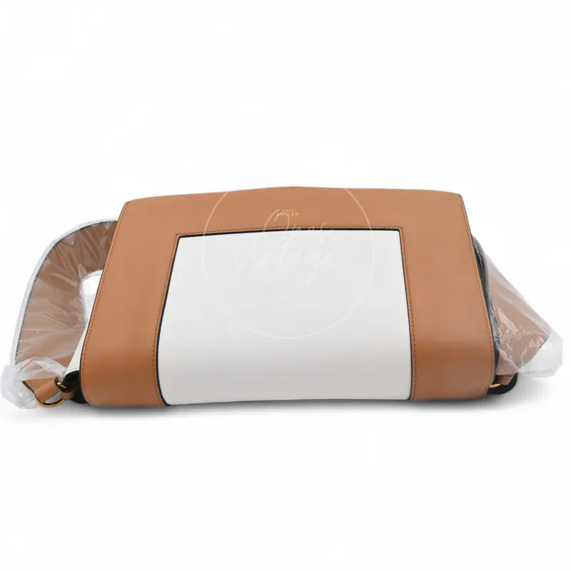 Celine Medium Frame Bag in tan and optic white calfskin, featuring tan and white color-blocked exterior and rectangular framed front panel, front view