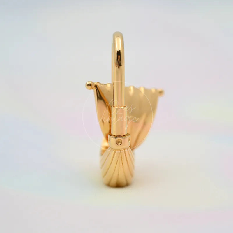 Hermès L'Air De Paris Yacht Cadena Charm in gold, featuring sailboat-inspired charm silhouette and top attachment loop, front view