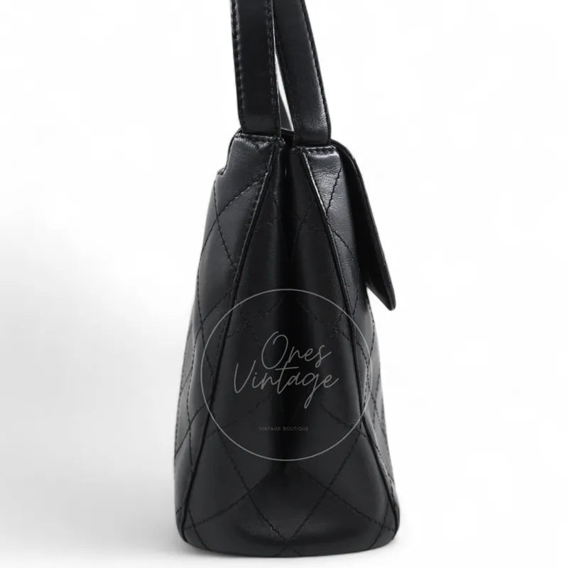 Chanel vintage turn-lock shoulder bag in black quilted lambskin with gold hardware, Series 5, right side profile