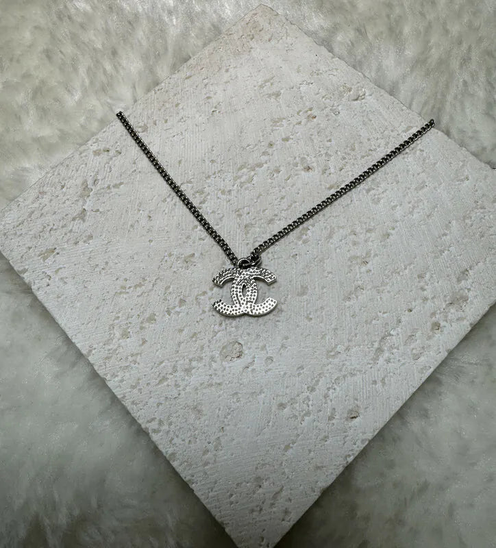 Chanel CC Mark Necklace in metal and crystal, featuring interlocking double-C pendant and crystal-accented pendant, front view