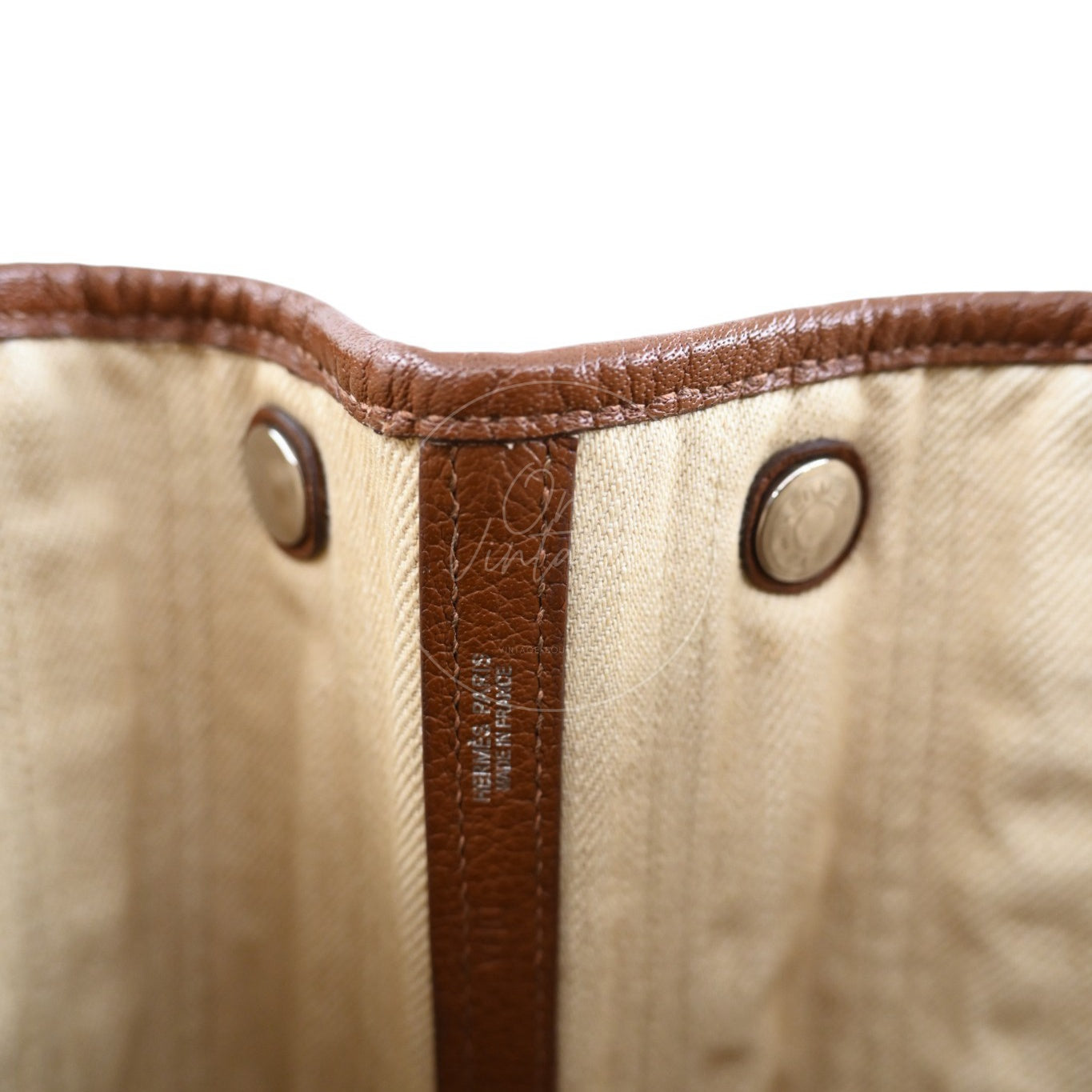 Close-up of Hermès Paris silver foil stamp and blind stamp on interior leather strap
