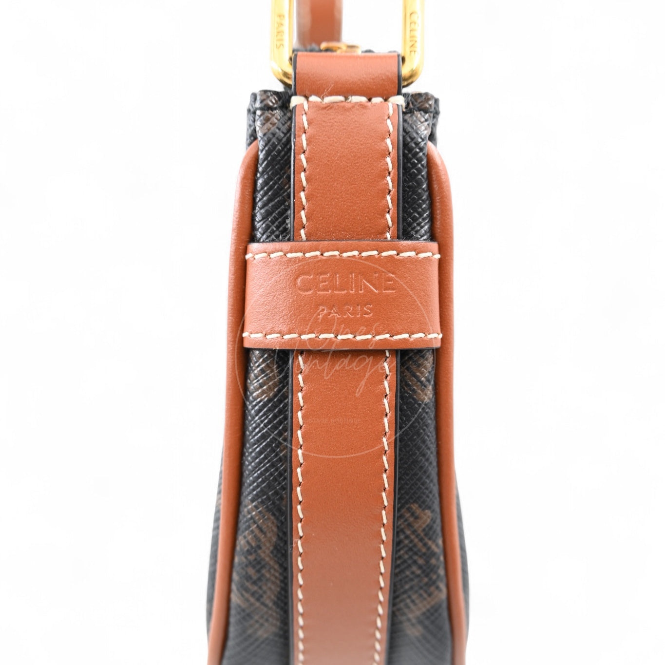 Close-up of debossed CELINE PARIS logo on tan leather trim of Ava bag