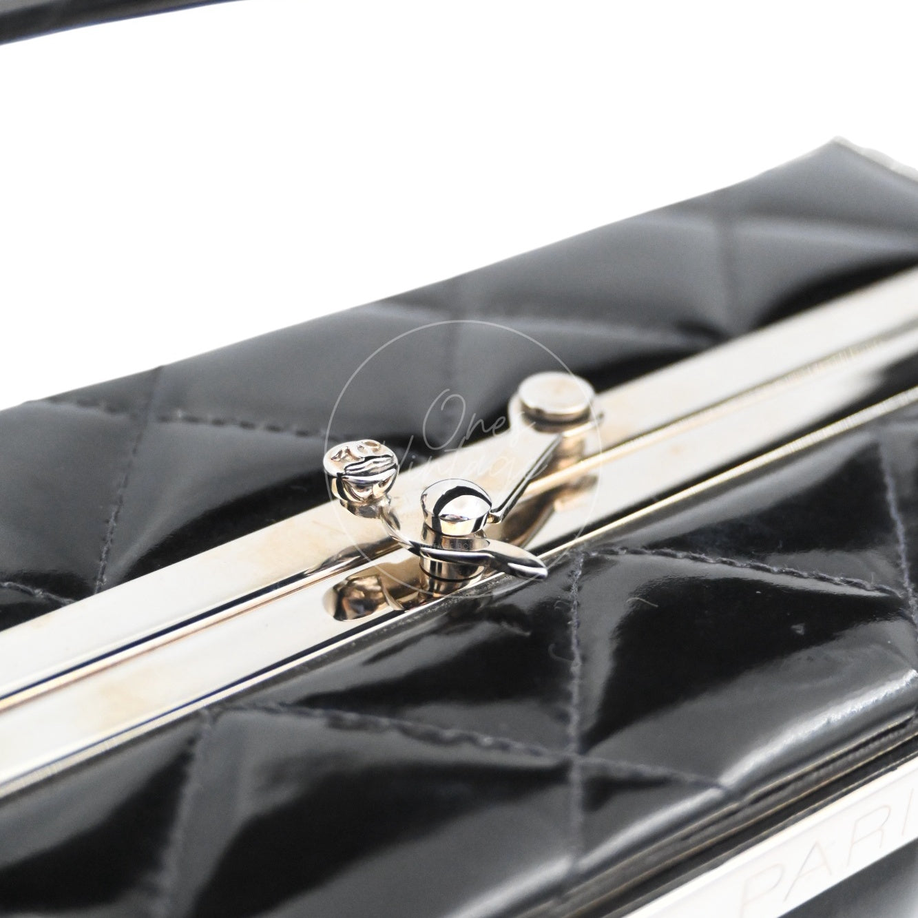 Close-up of vintage silver-tone metal mechanical clasp lock on top of Chanel vanity box