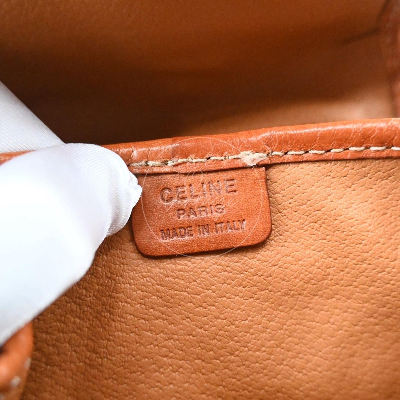 Debossed CELINE PARIS MADE IN ITALY logo stamp on interior leather tag of a vintage pouch