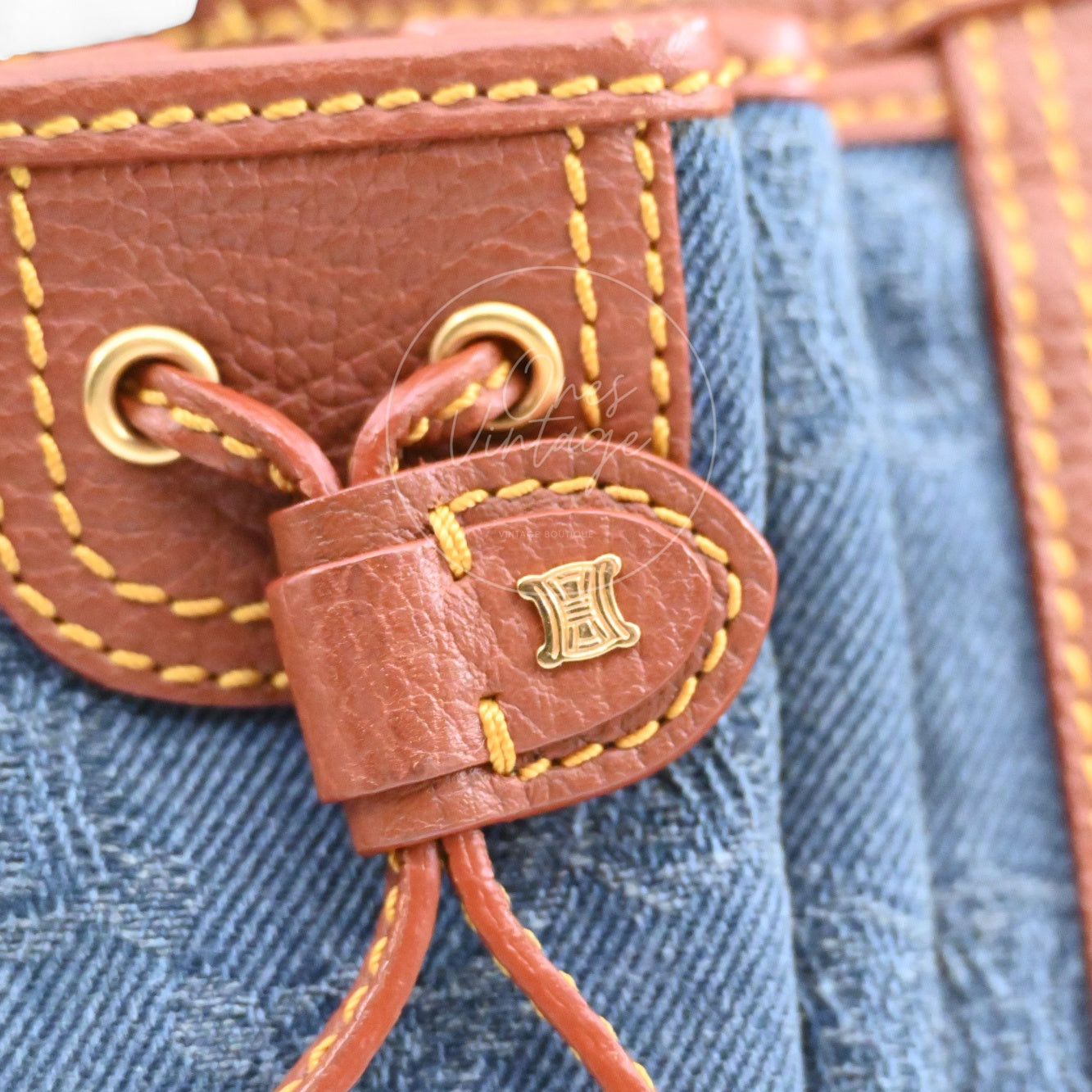 Debossed CELINE logo on interior brown leather tag with gold rivets inside vintage bag