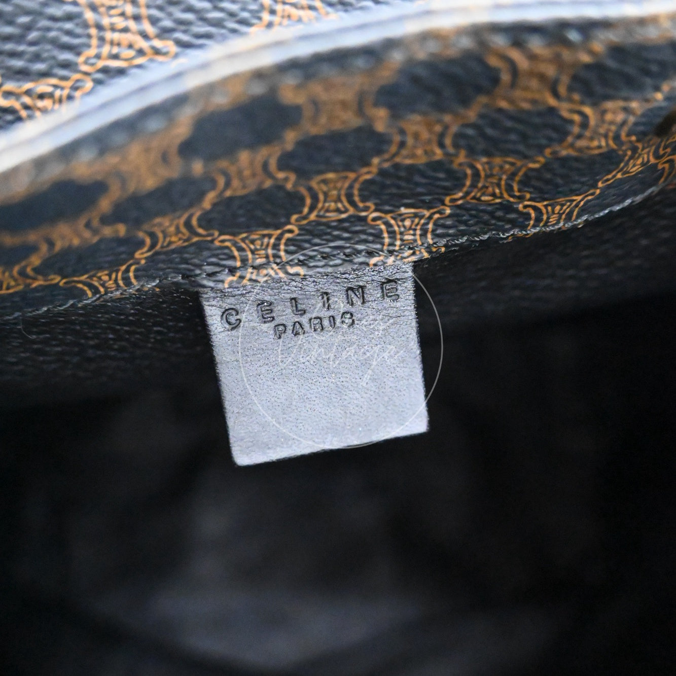 Debossed CELINE PARIS logo on small black leather interior tag inside vintage bag