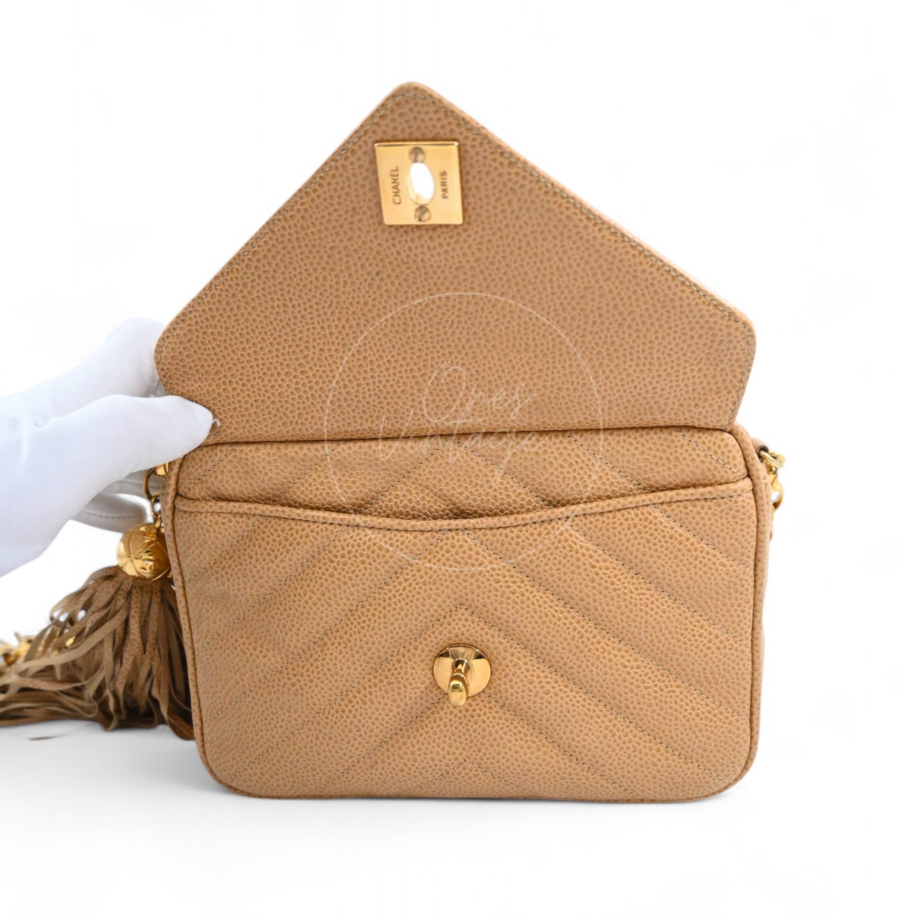 Open view of Chanel vintage Chevron leather bag showing front pocket and interior flap hardware