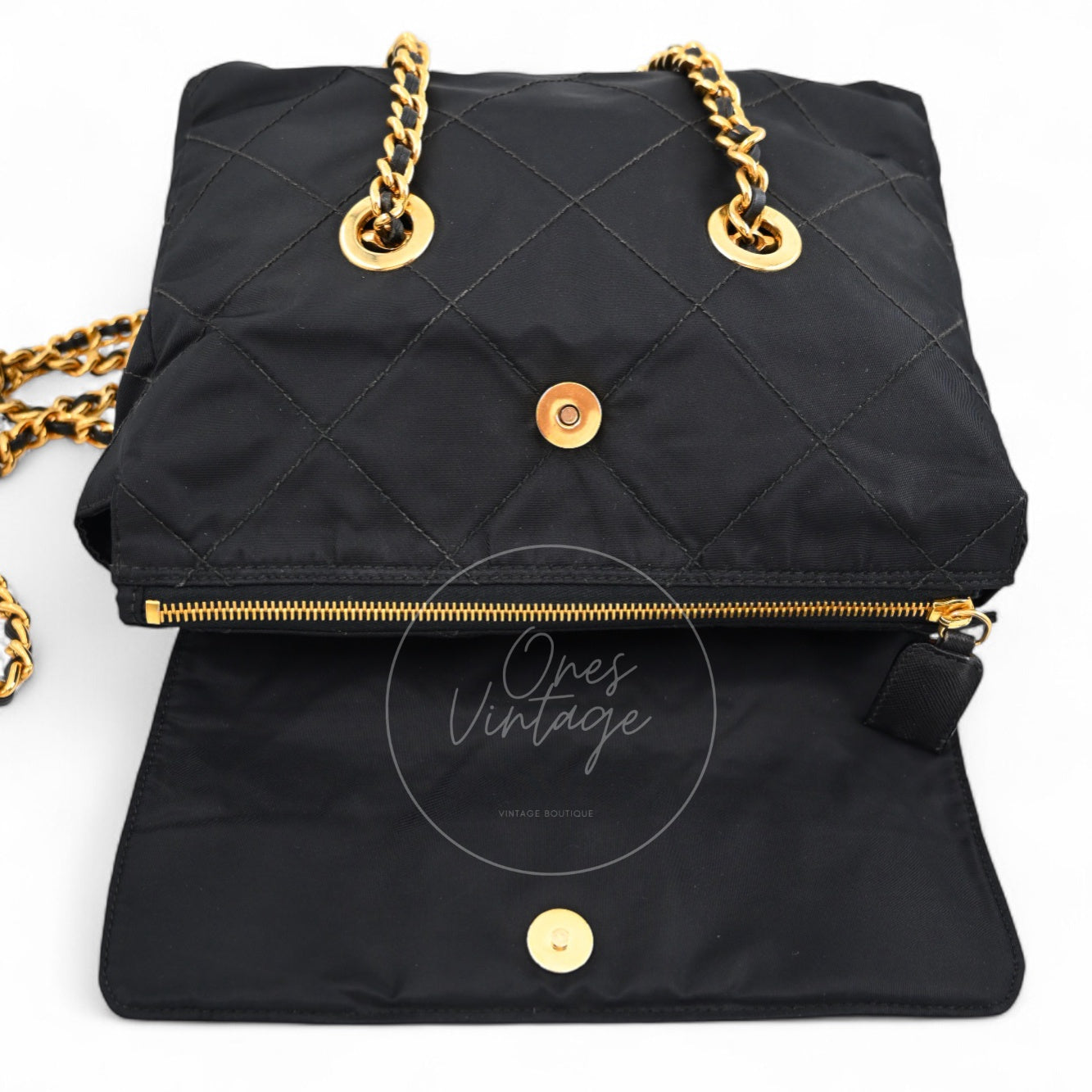 Open view of Prada vintage quilted bag showing magnetic closure and gold-tone zipper