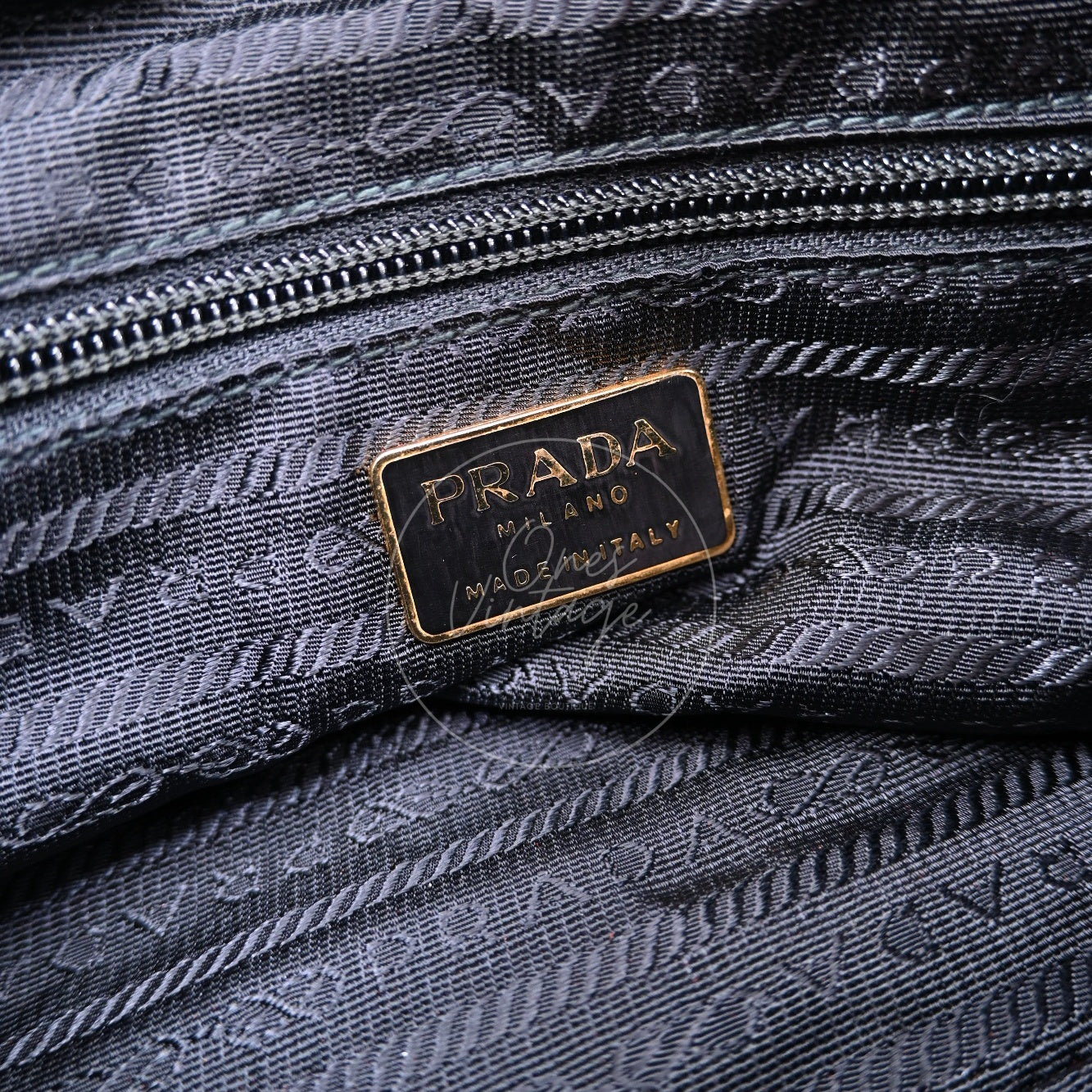 Gold engraved PRADA MILANO MADE IN ITALY logo plate with jacquard fabric lining inside vintage bag