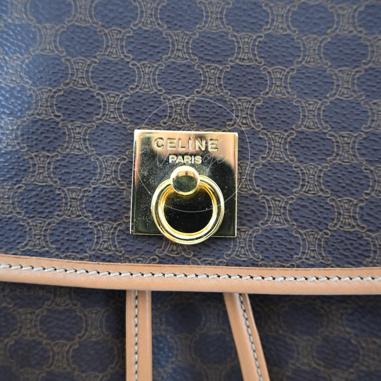 Close-up of engraved CELINE PARIS gold-tone square ring lock hardware on vintage backpack