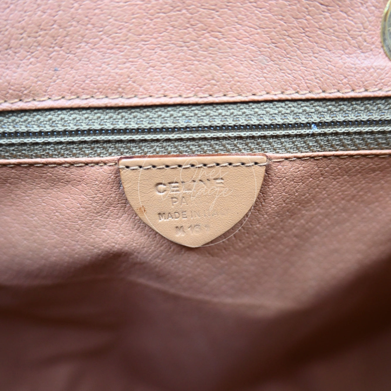 Debossed CELINE PARIS MADE IN ITALY stamp and M 16 1 serial code on interior leather tag