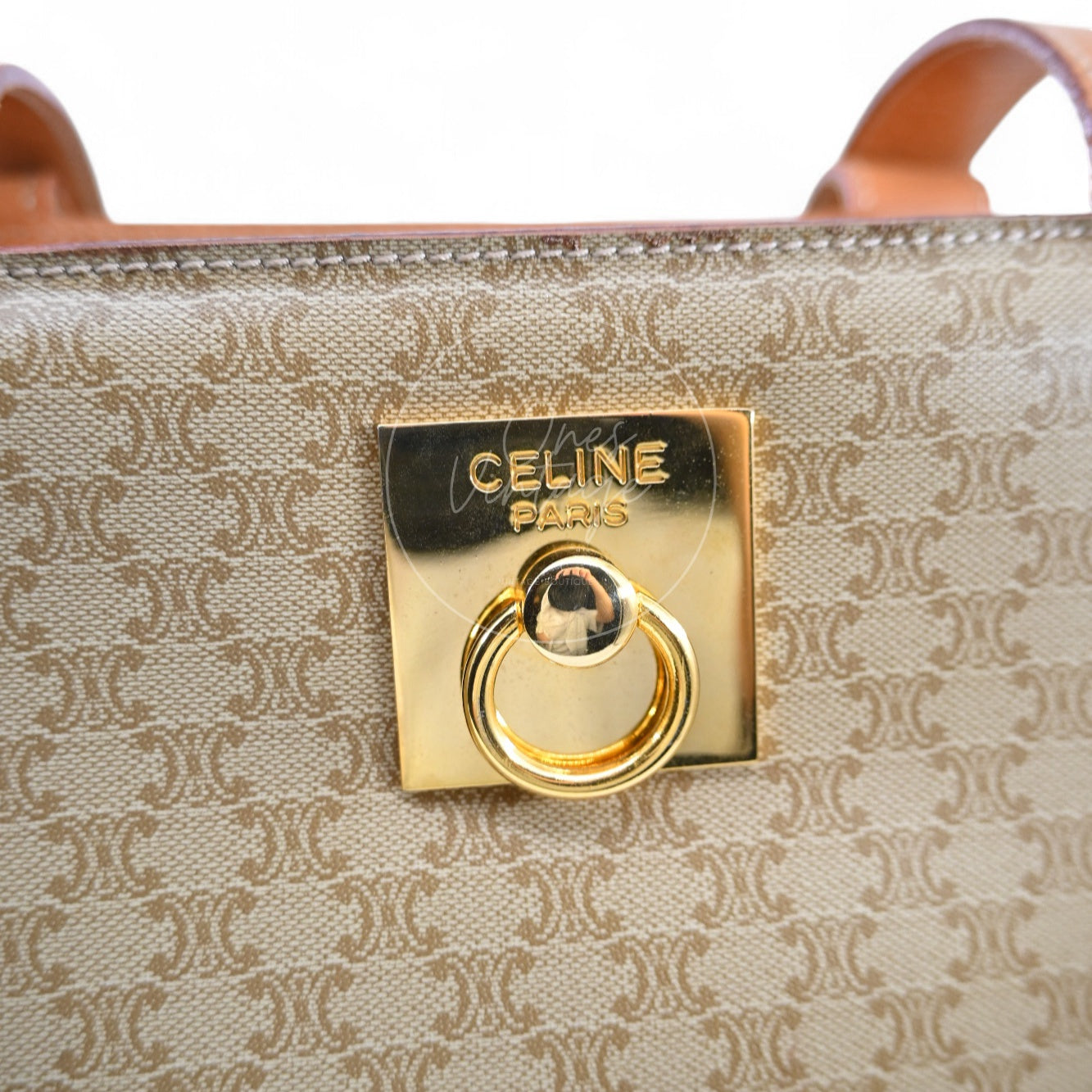 Close-up of engraved CELINE PARIS gold-tone square door-knocker lock hardware