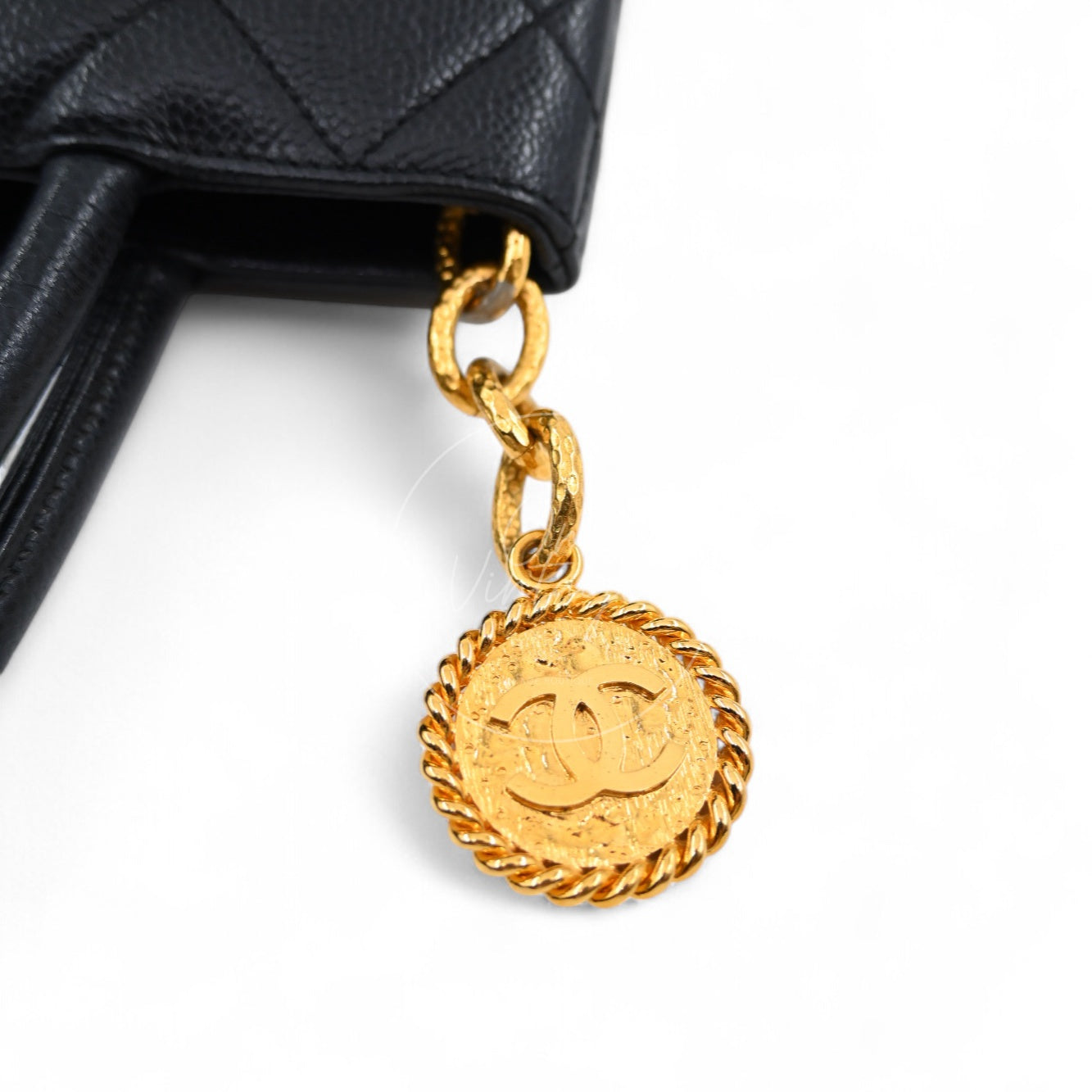 Close-up of vintage Chanel gold-tone round Medallion pull charm with interlocking CC logo