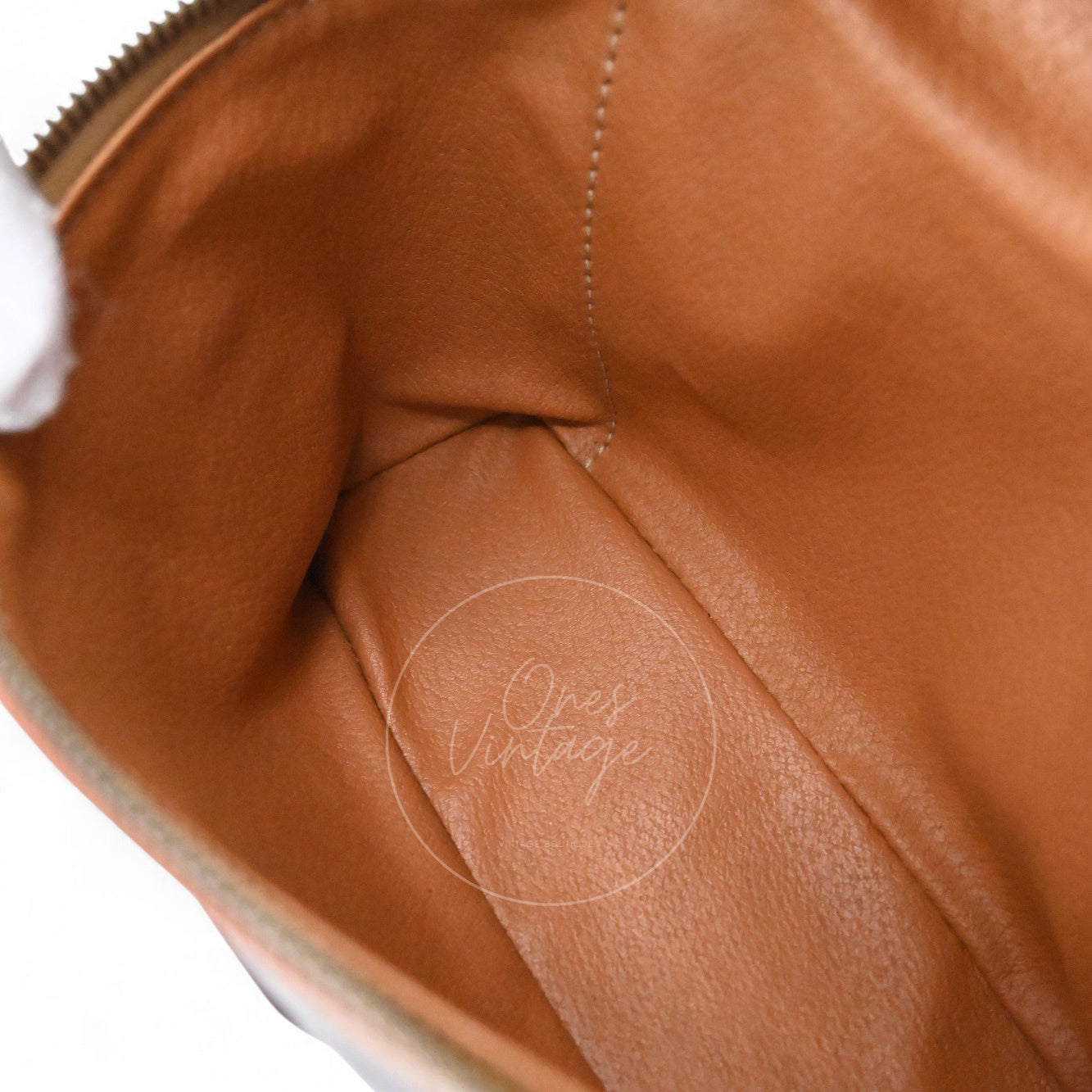 Inside view of Céline vintage vanity bag showing spacious main compartment with tan leather interior