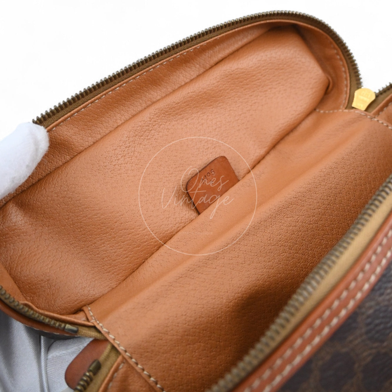 Interior view of open Céline vanity box showing tan leather lining and small serial number leather