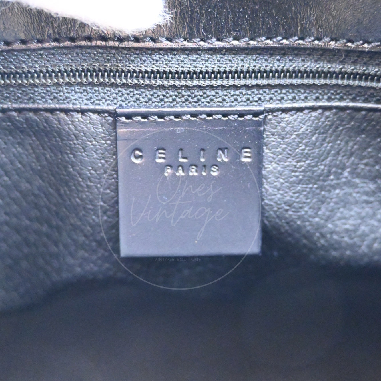 Debossed CELINE PARIS logo on interior black leather tag of vintage bag