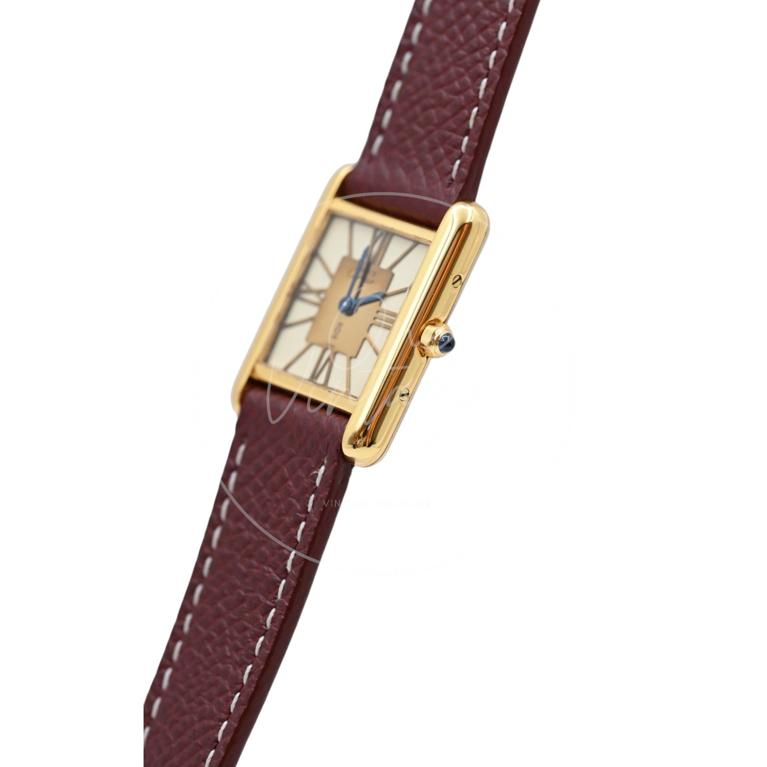 Cartier Must de Tank quartz watch with ivory Roman numeral dial and maroon leather strap, angled crown-side view with blue cabochon