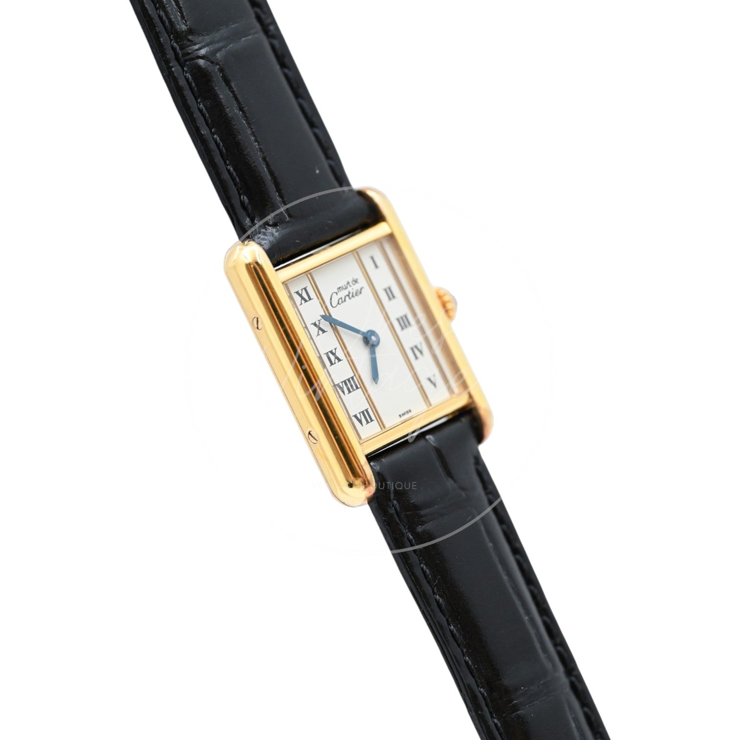Cartier Must de Tank quartz watch with ivory Roman numeral dial and black leather strap, angled left profile of the gold-tone rectangular case