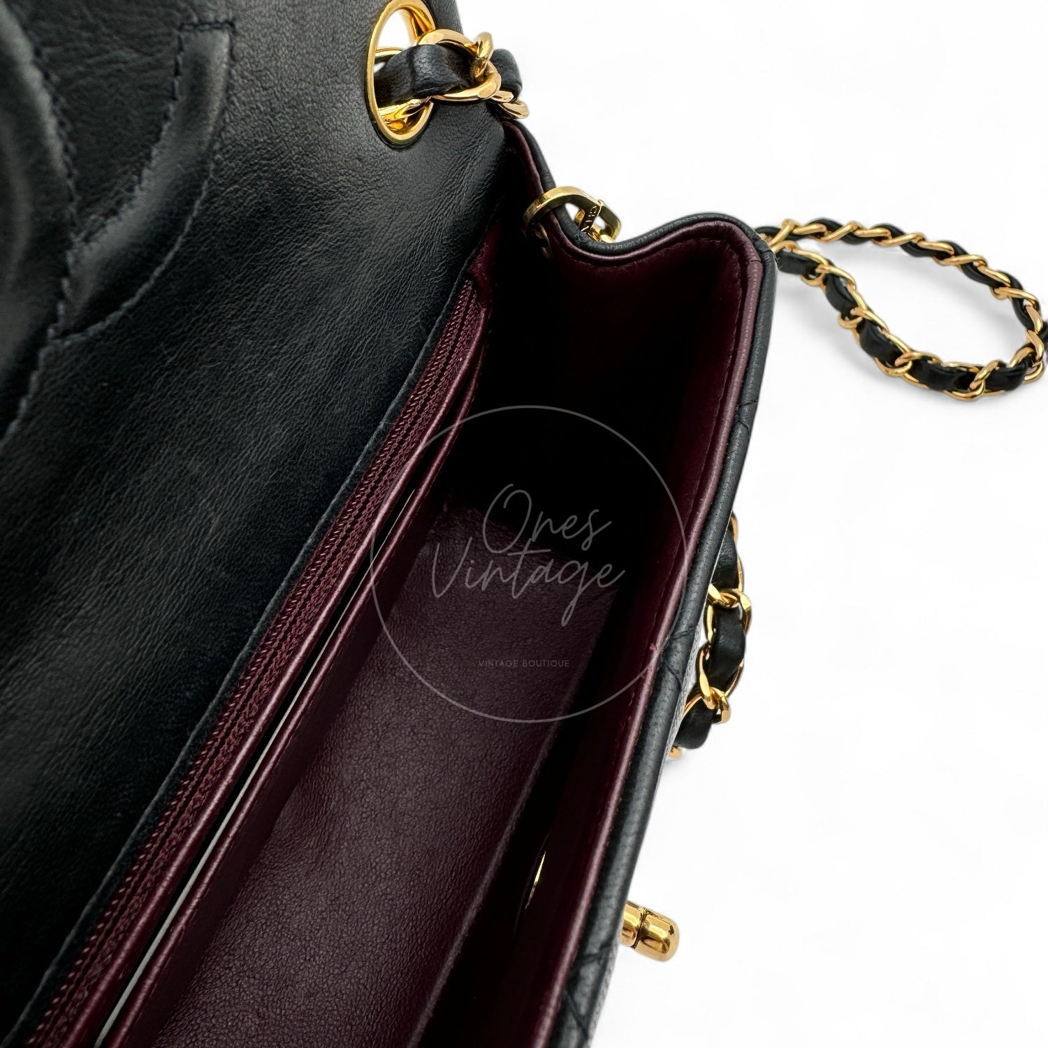 Interior view of Chanel Square Mini bag showing burgundy leather lining and zipper pocket