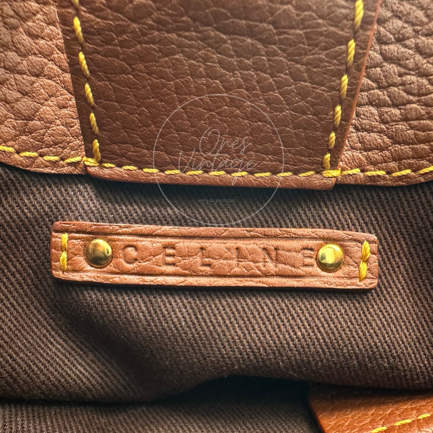 Debossed CELINE logo on interior brown leather tag with gold rivets inside vintage bag