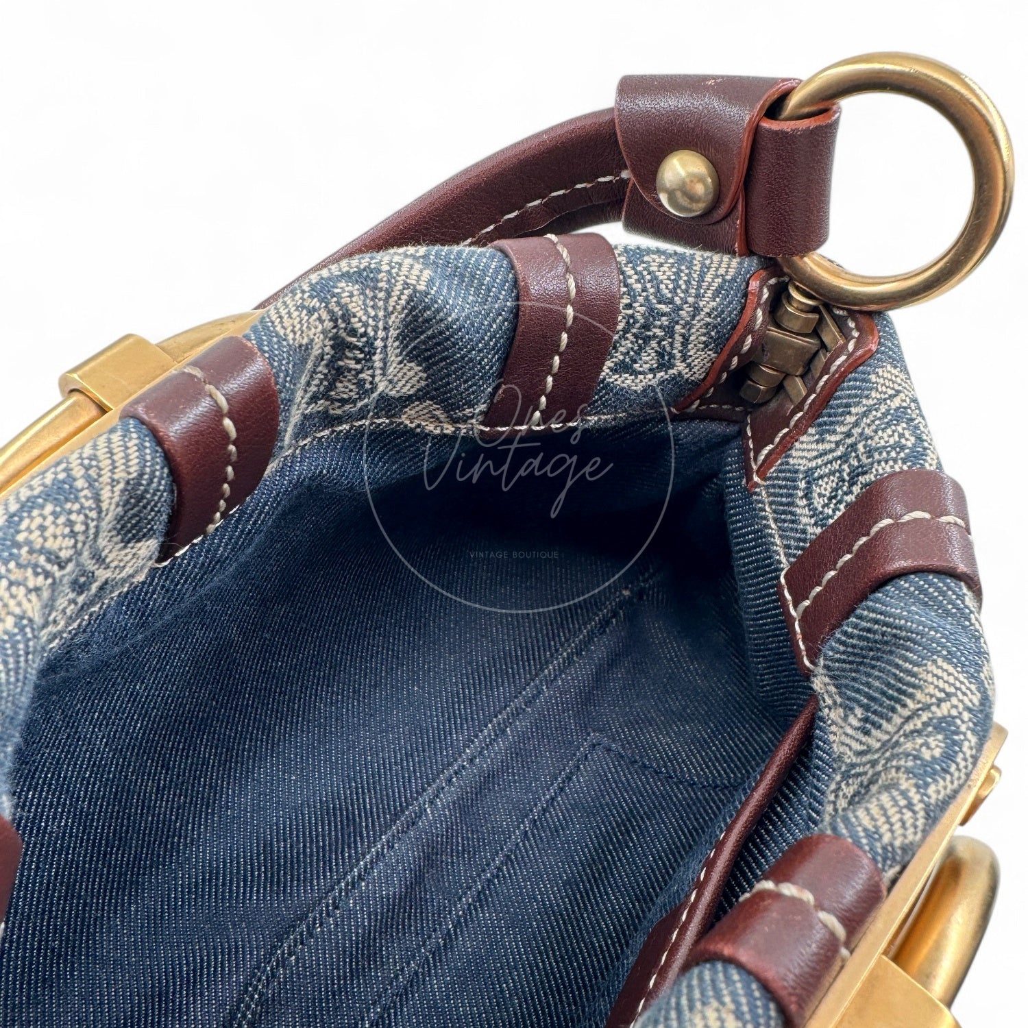 Interior view of open Céline vintage denim bag showing denim lining and top leather trim