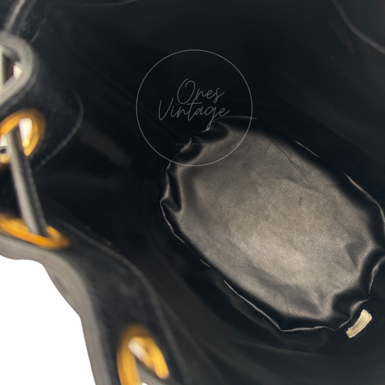 Interior view of open Chanel vintage caviar leather backpack showing roomy compartment