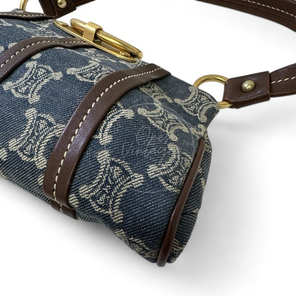 Side view of Céline vintage denim bag showing cylindrical structure and leather piping