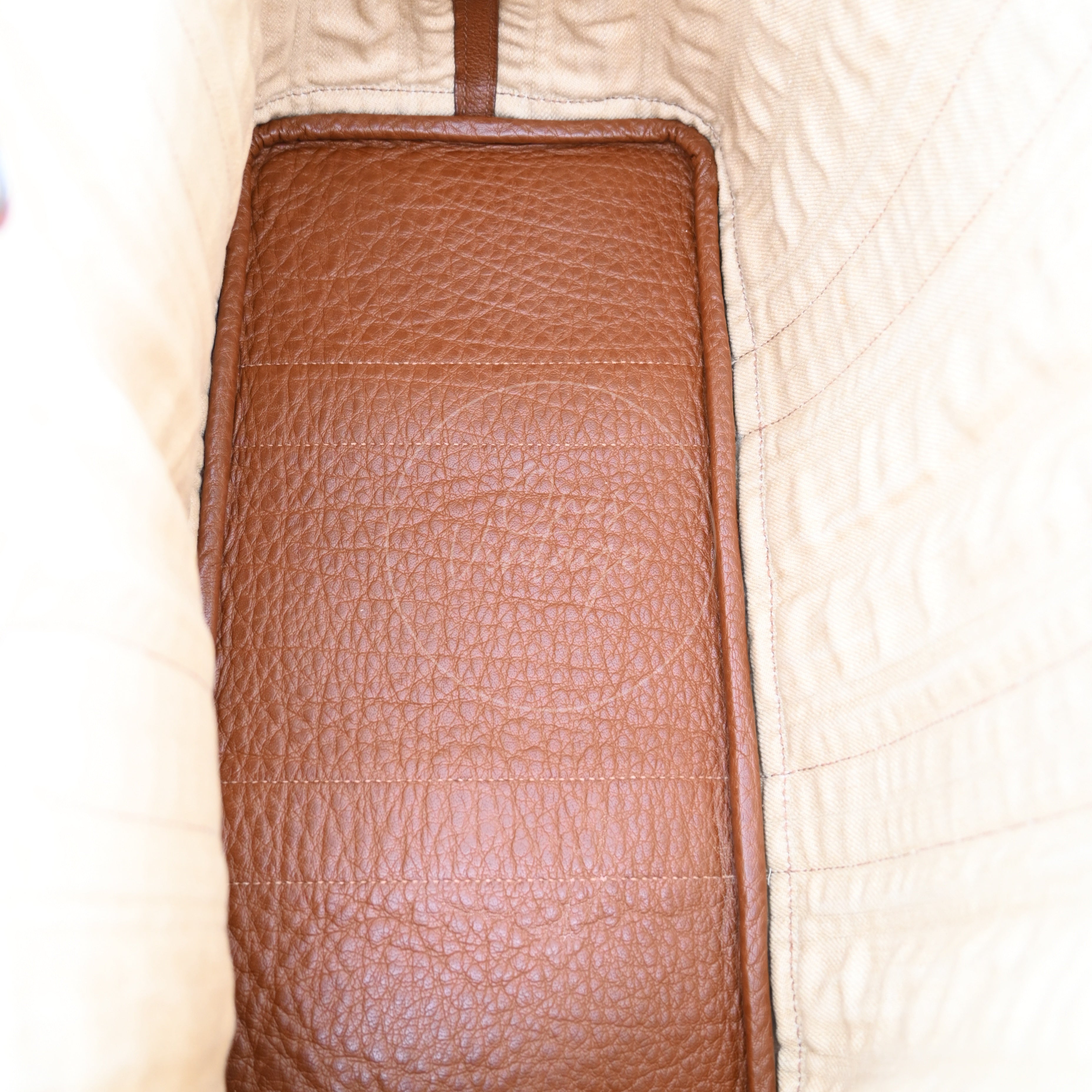 Interior view of Hermès Garden Party bag showing roomy compartment and brown leather base