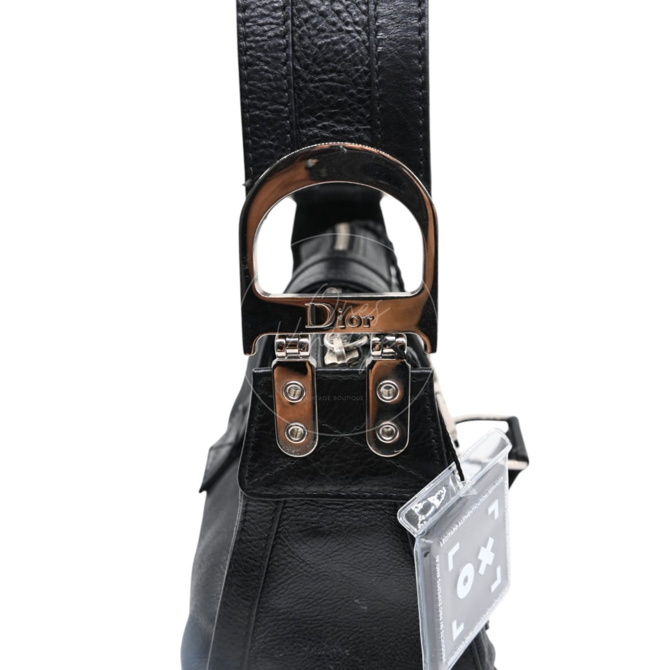 Close-up of engraved Dior logo on silver-tone D-ring hardware of Street Chic bag