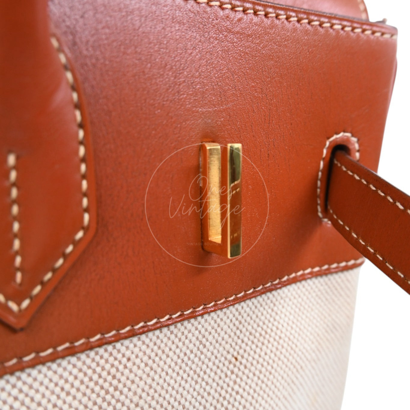 Hermès Haut à Courroies 32 in Fauve Barenia leather and beige toile with gold-tone hardware, Circle X stamp, left turn-lock post close-up