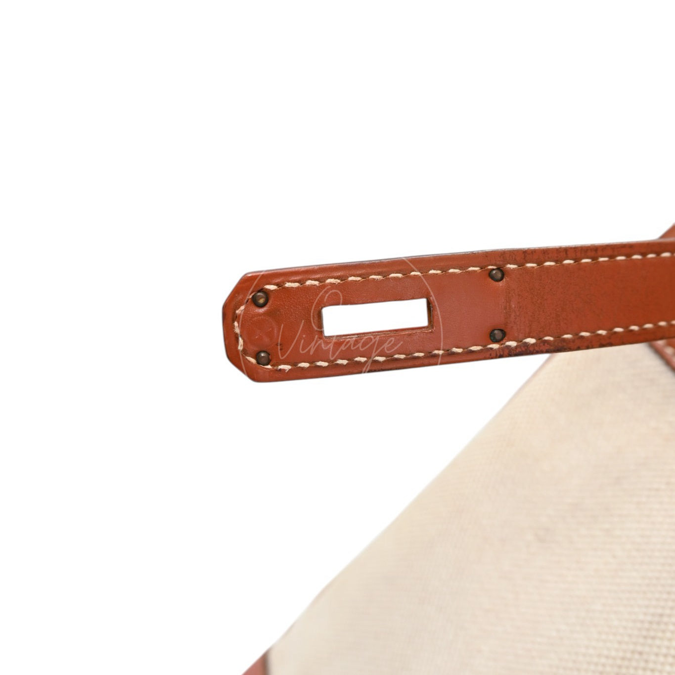 Hermès Haut à Courroies 32 in Fauve Barenia leather and beige toile with gold-tone hardware, Circle X stamp, underside of the right closure strap