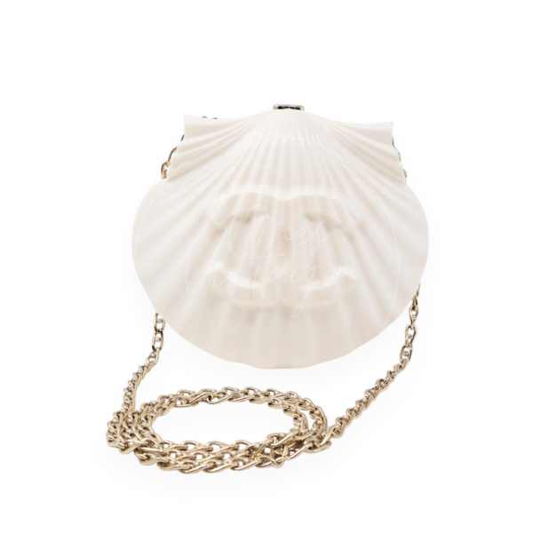 Chanel Evening on the Beach shell minaudière in cream-white plexiglass with gold-tone hardware, front view with chain strap