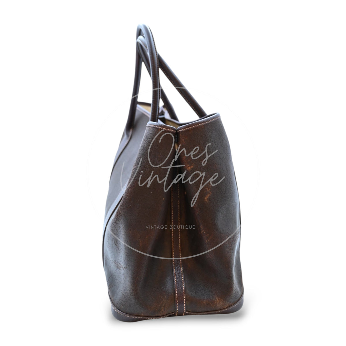 Hermès Garden Party 36 Amazon tote in dark brown rubber with leather trim, left side profile with snap-fastened gusset