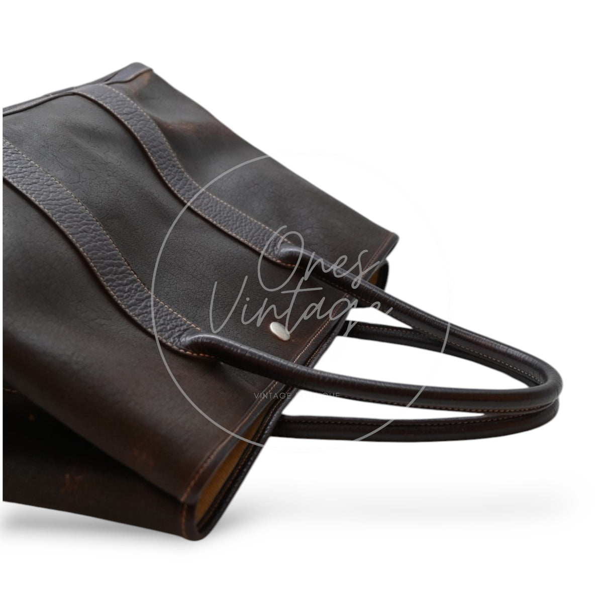 Hermès Garden Party 36 Amazon tote in dark brown rubber with leather trim, angled top view of leather handles and side snap